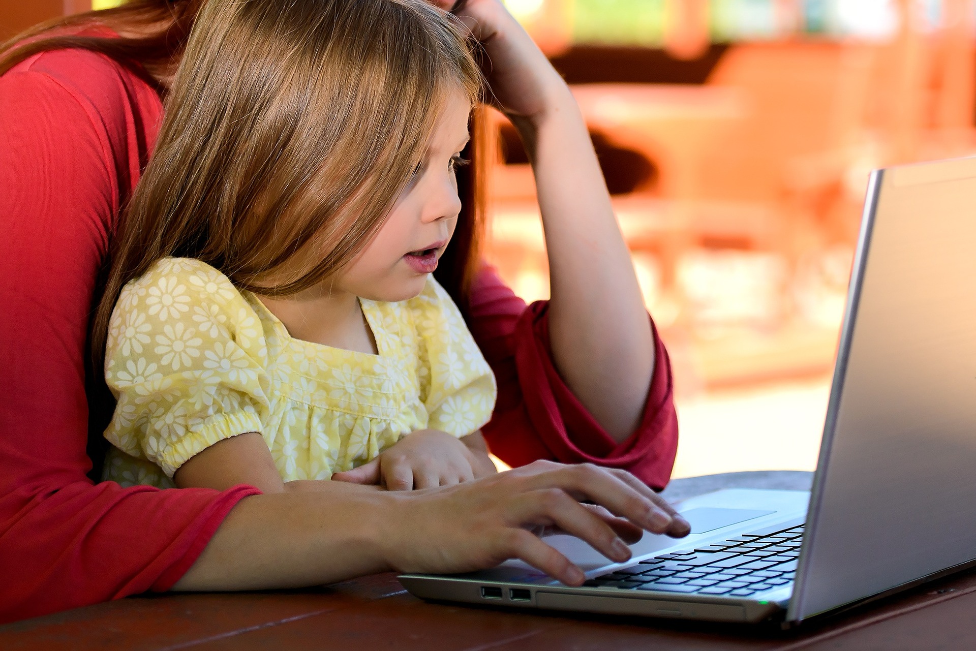 Child and parent using a laptop